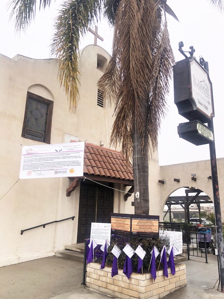 Purple flags, banner at St. Isidore remind us of hunger and homelessness